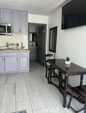 a kitchen with stainless steel appliances a stove a sink a microwave and a refrigerator