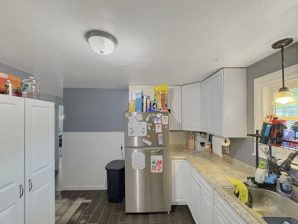 4 Cuff Avenue Springfield, MA 01104 - Photo 3 of 24 a view of a kitchen with fridge and workspace