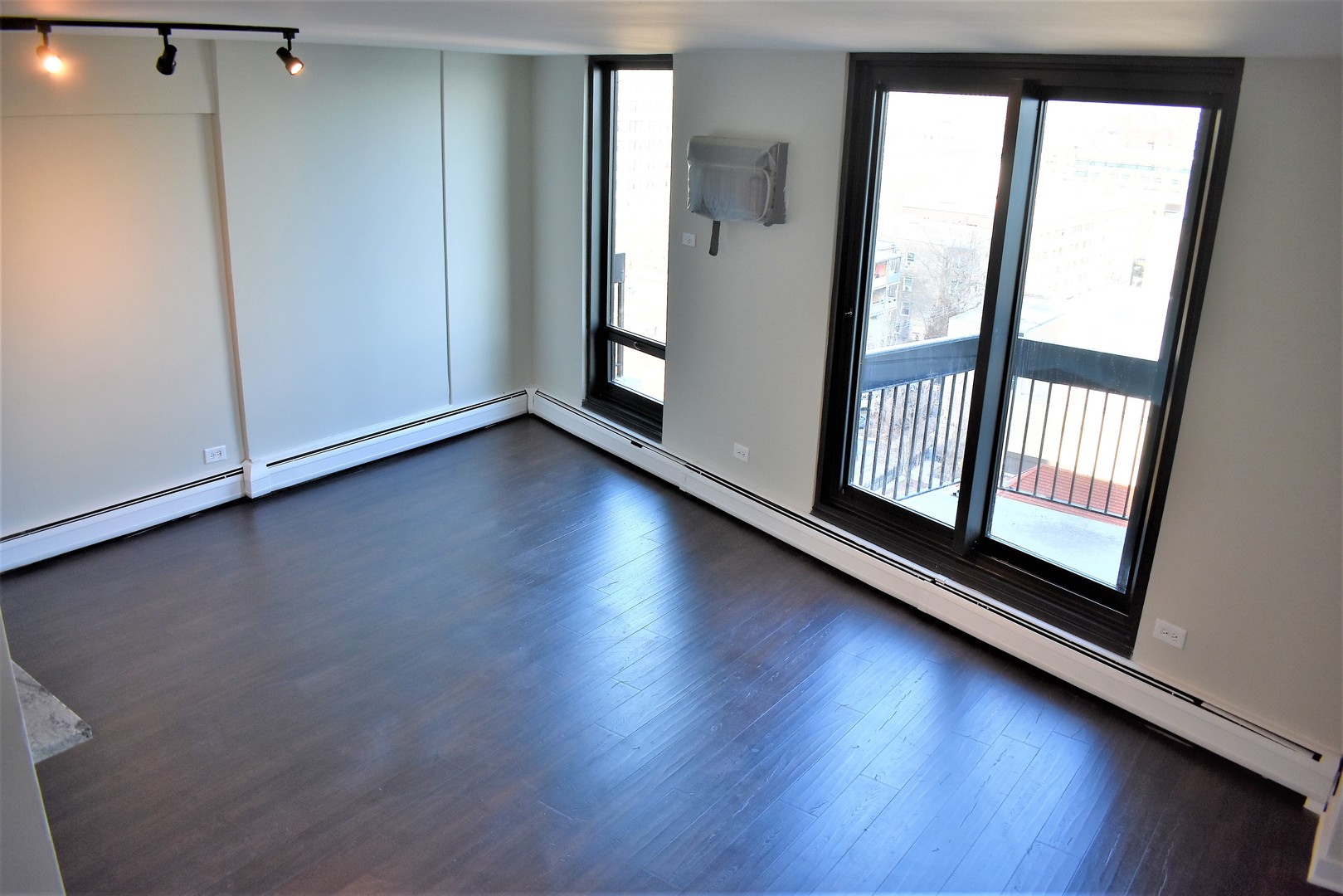 6166 North Sheridan Road, Unit 10D Chicago, IL 60660 - Photo 2 of 23 an empty room with wooden floor and windows