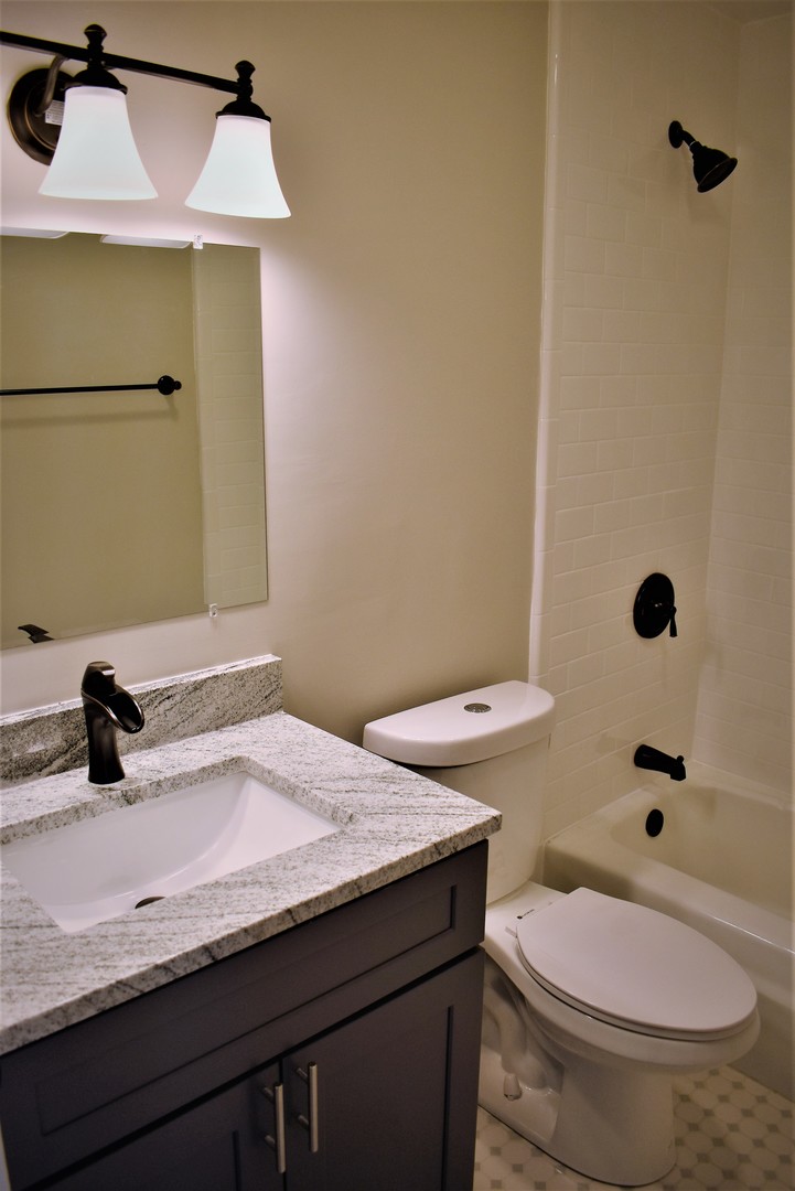 6166 North Sheridan Road, Unit 10D Chicago, IL 60660 - Photo 13 of 23 a bathroom with a sink a toilet and shower