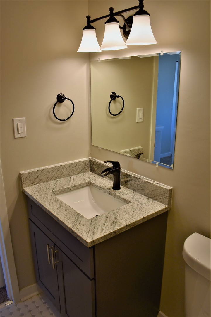 6166 North Sheridan Road, Unit 10D Chicago, IL 60660 - Photo 15 of 23 a bathroom with a granite countertop sink and a mirror
