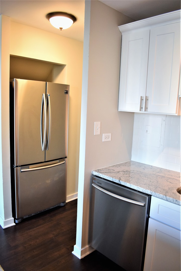 6166 North Sheridan Road, Unit 10D Chicago, IL 60660 - Photo 6 of 23 a white refrigerator freezer sitting in a kitchen