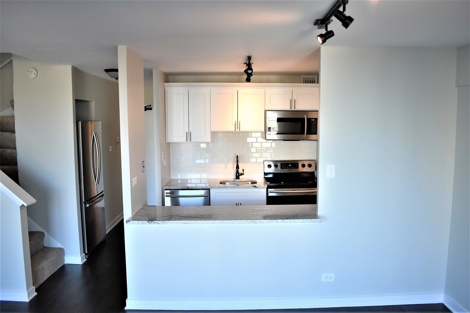 6166 North Sheridan Road, Unit 10D Chicago, IL 60660 - Photo 8 of 23 a kitchen with stainless steel appliances a stove top oven a sink and a refrigerator