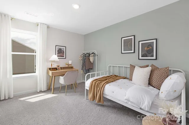 a spacious bedroom with a bed and a table