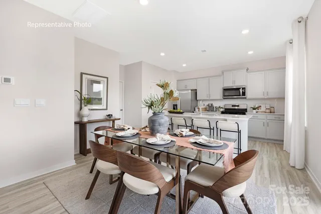 a dining room with kitchen island furniture a dining table and chairs
