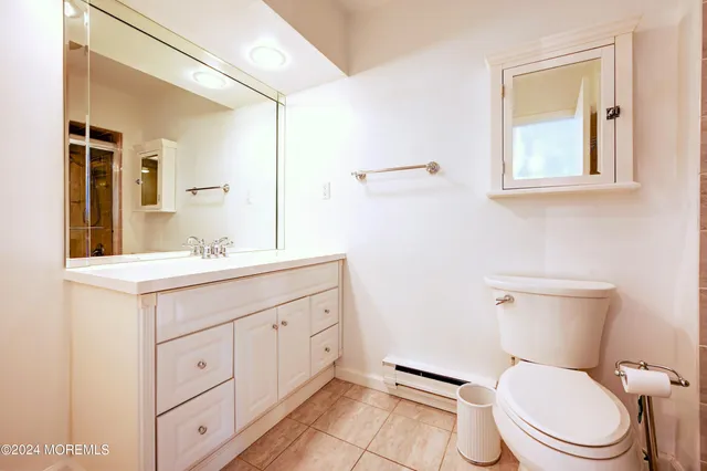 a bathroom with a shower a toilet and a sink