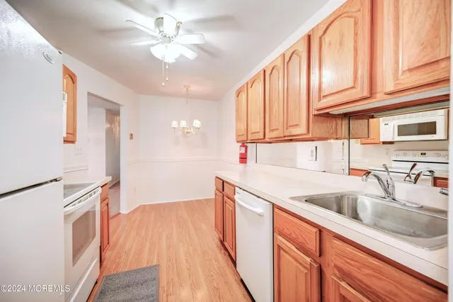 a kitchen with stainless steel appliances granite countertop a sink and dishwasher with wooden floor