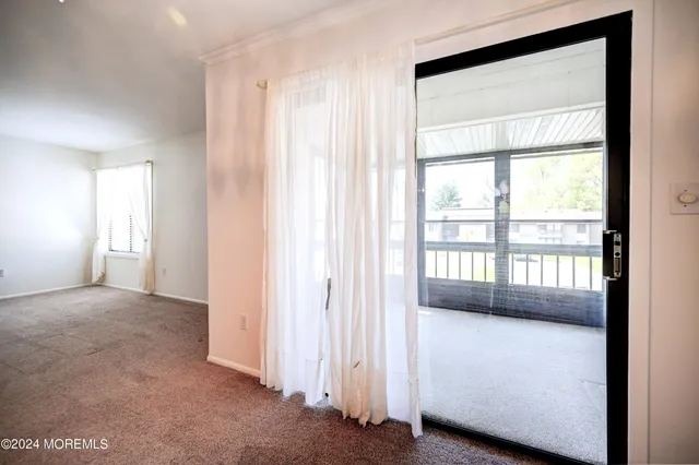a view of an empty room with a balcony