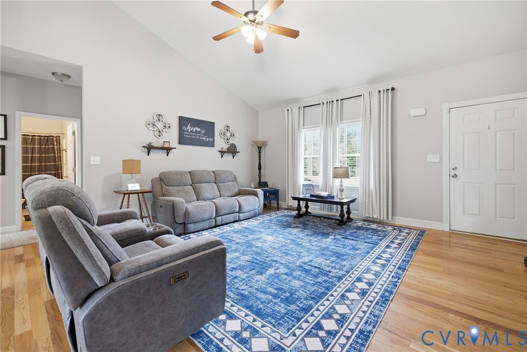 9433 Robin Road Disputanta, VA 23842 - Photo 5 of 26 Living area featuring vaulted ceilings, light wood