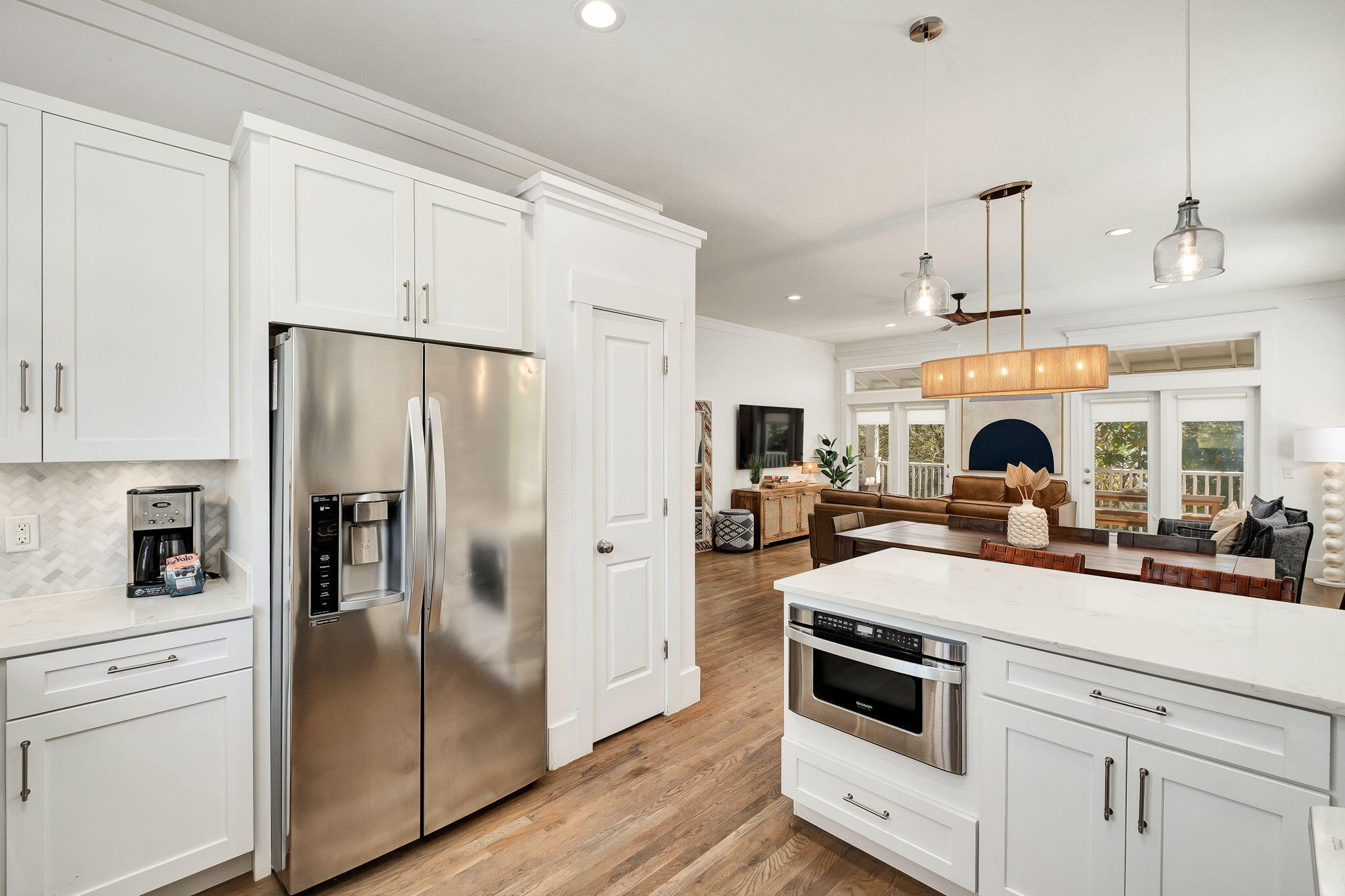 3319 East County Highway 30A Santa Rosa Beach, FL 32459 - Photo 11 of 44 a kitchen with stainless steel appliances a refrigerator stove and white cabinets