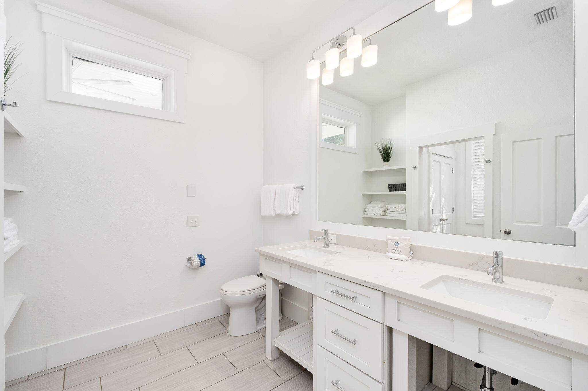3319 East County Highway 30A Santa Rosa Beach, FL 32459 - Photo 18 of 44 a bathroom with a double vanity sink toilet and a mirror