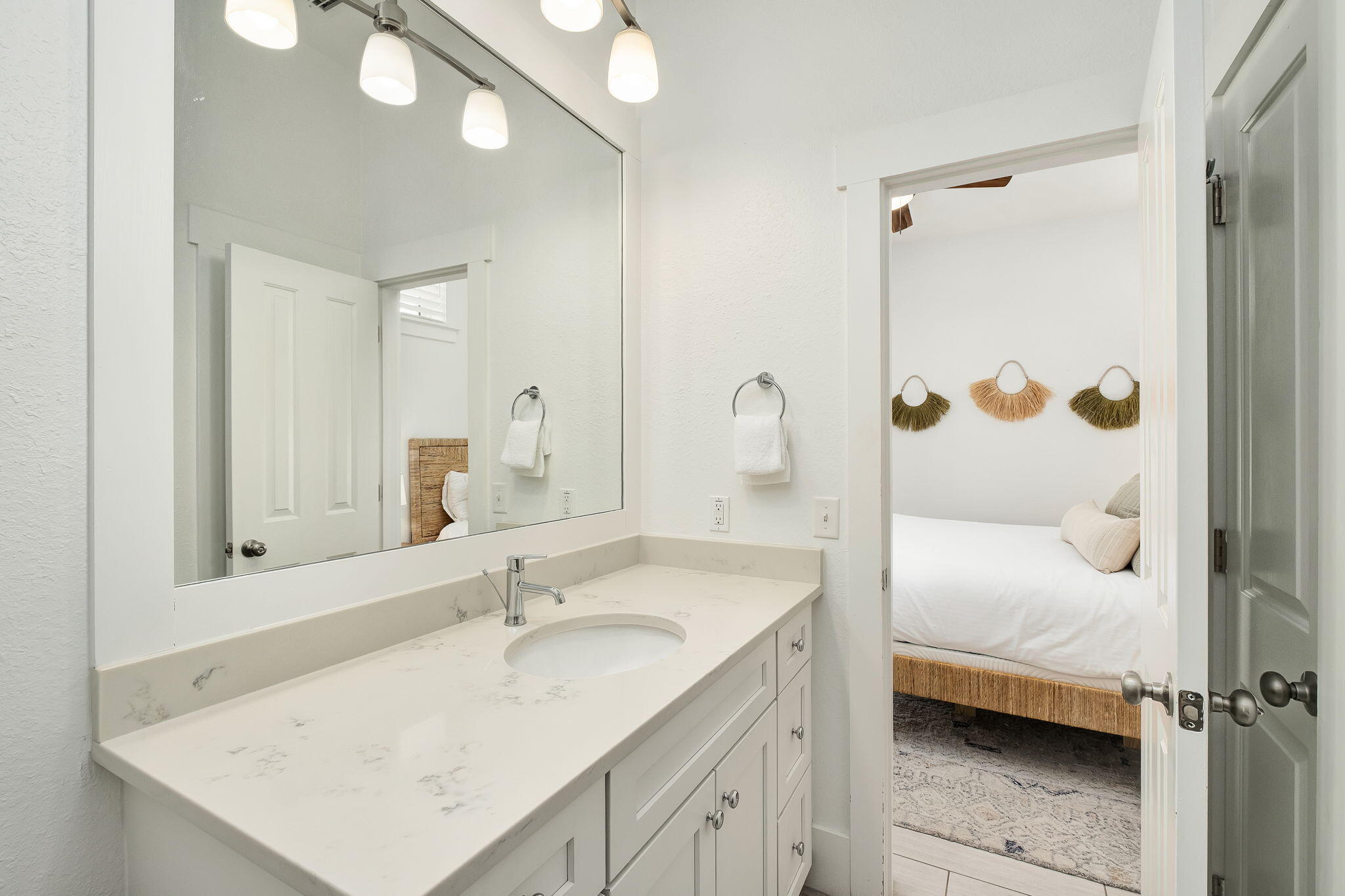 3319 East County Highway 30A Santa Rosa Beach, FL 32459 - Photo 20 of 44 a bathroom with a sink a mirror and a shower