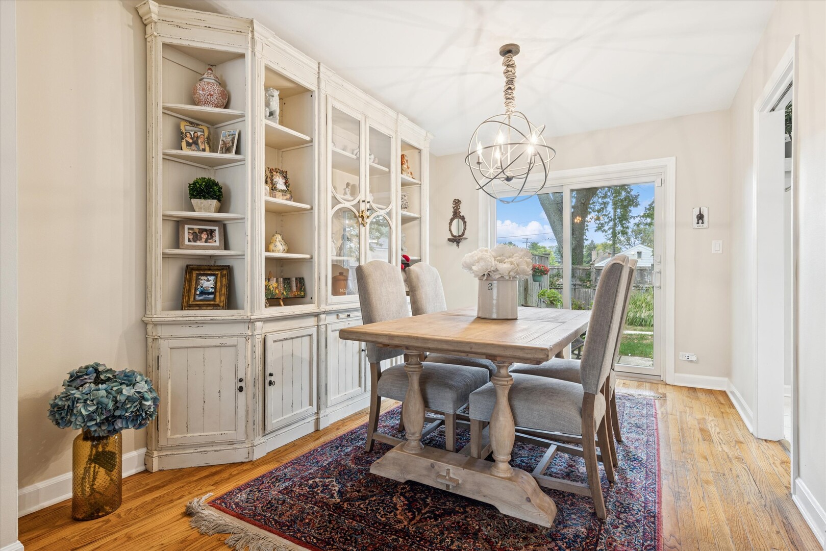 494 Old Surrey Road Hinsdale, IL 60521 - Photo 5 of 21 a dining room with wooden floor a chandelier a wooden table and chairs