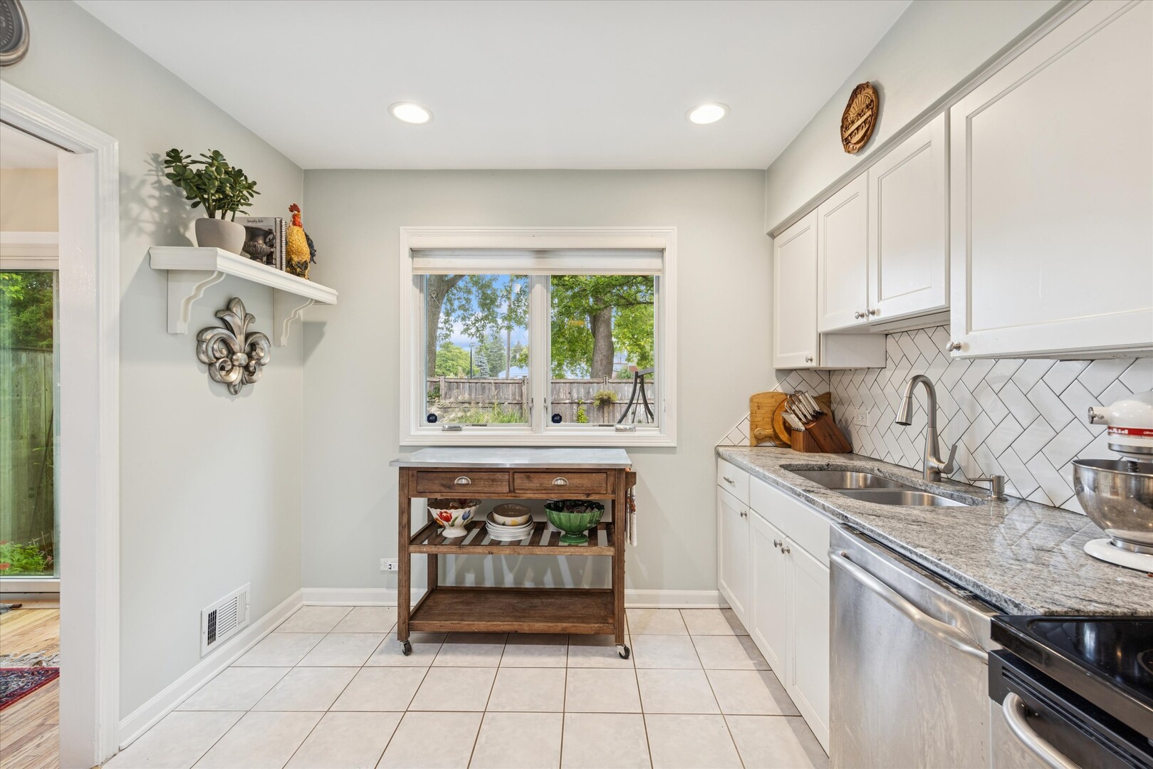 494 Old Surrey Road Hinsdale, IL 60521 - Photo 6 of 21 a kitchen with stainless steel appliances granite countertop a stove a sink and a microwave