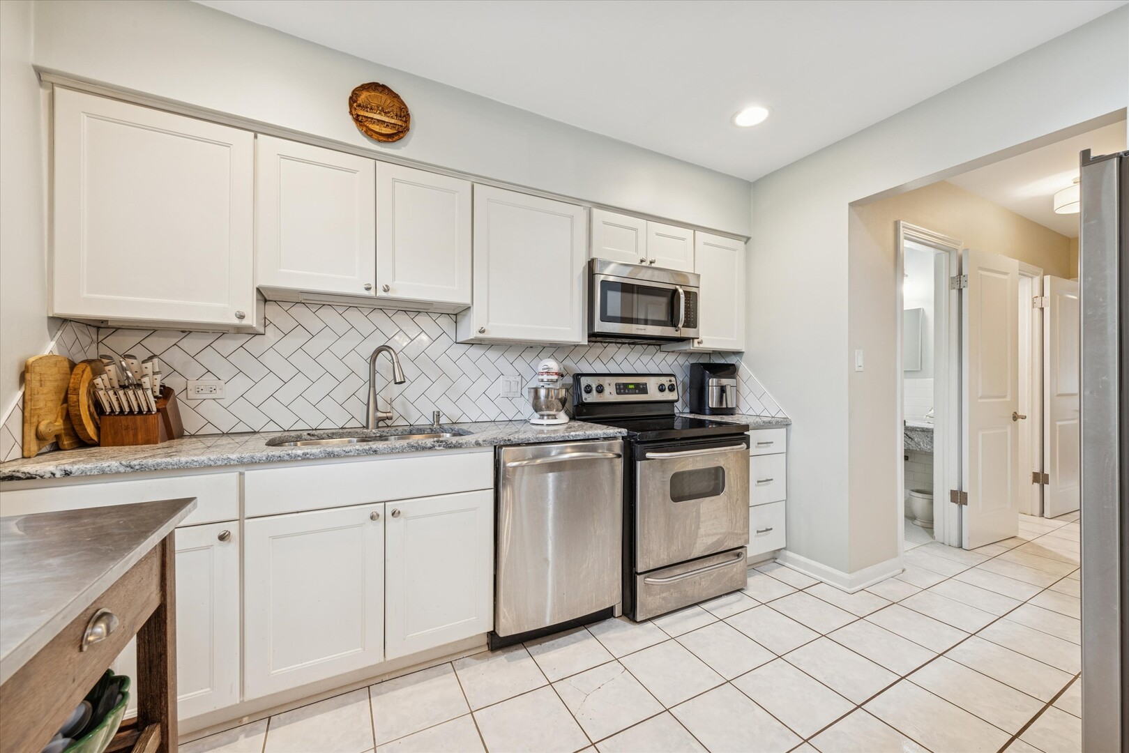 494 Old Surrey Road Hinsdale, IL 60521 - Photo 8 of 21 a kitchen with white cabinets sink and stainless steel appliances
