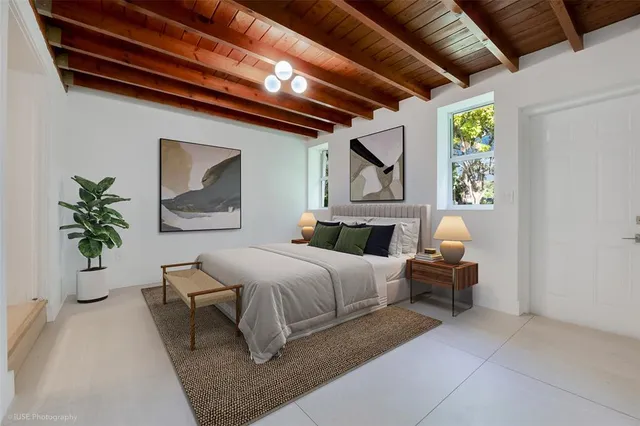 a bed room with a bed and a potted plant