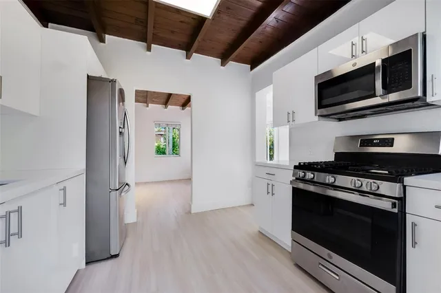 a kitchen with a stove and a microwave