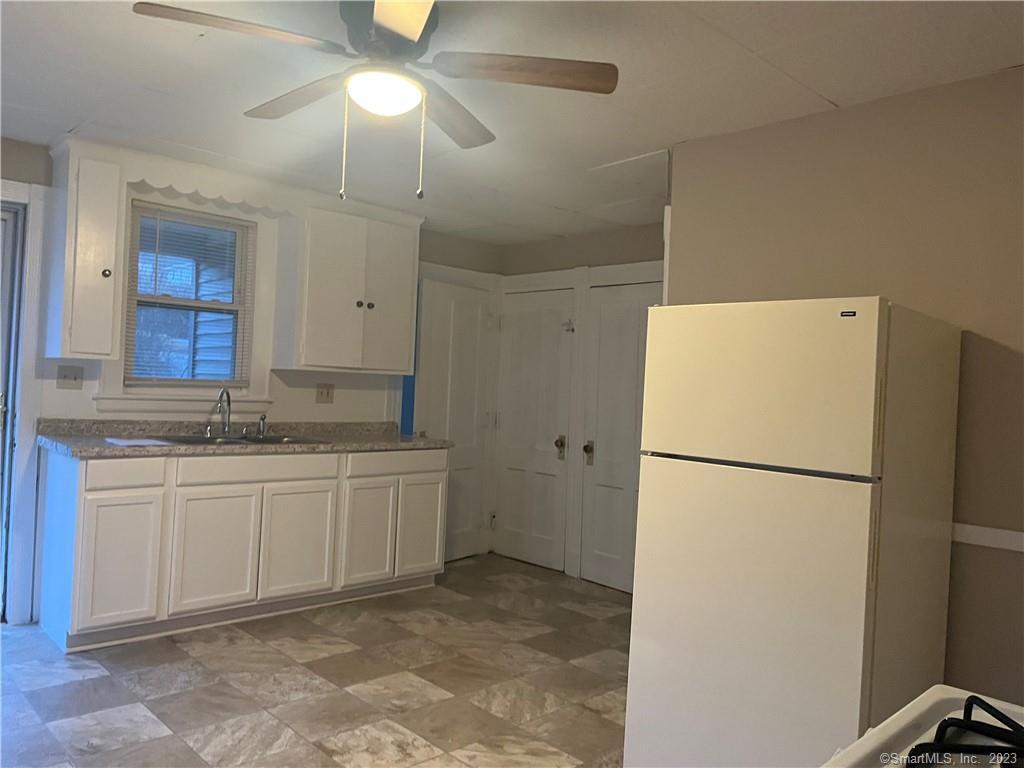 253 North Main Street, Unit 1 Naugatuck, CT 06770 - Photo 4 of 11 a kitchen with a refrigerator a stove a sink and a refrigerator
