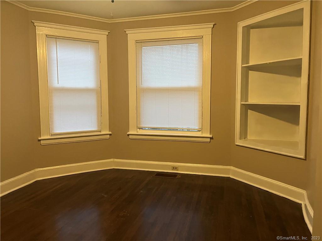 253 North Main Street, Unit 1 Naugatuck, CT 06770 - Photo 5 of 11 a view of an empty room with wooden floor and a window