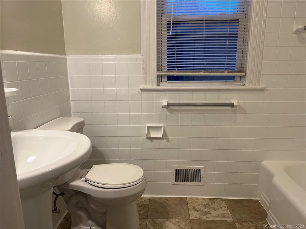 253 North Main Street, Unit 1 Naugatuck, CT 06770 - Photo 9 of 11 a bathroom with a toilet a sink and a window