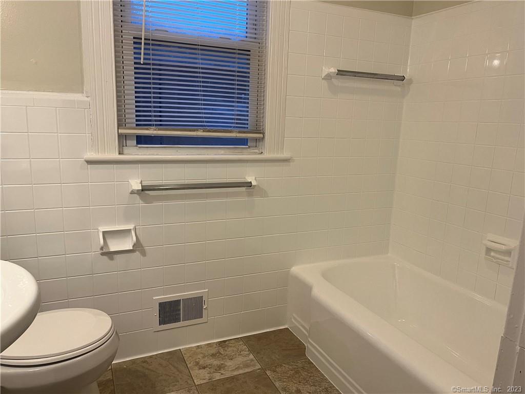 253 North Main Street, Unit 1 Naugatuck, CT 06770 - Photo 10 of 11 a white toilet sitting next to a bath tub