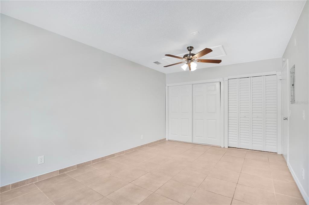 1537 Rivers Edge Drive Orlando, FL 32825 - Photo 13 of 30 an empty room with closet and a ceiling fan