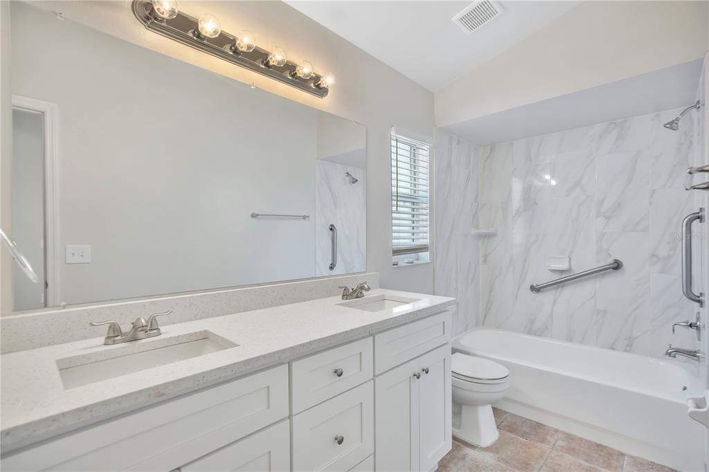 1537 Rivers Edge Drive Orlando, FL 32825 - Photo 15 of 30 a bathroom with a granite countertop sink a toilet and a bathtub