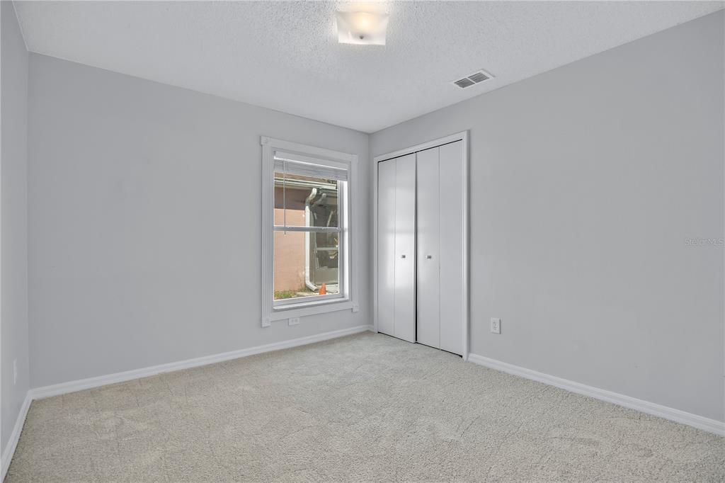 1537 Rivers Edge Drive Orlando, FL 32825 - Photo 20 of 30 an empty room with windows and closet