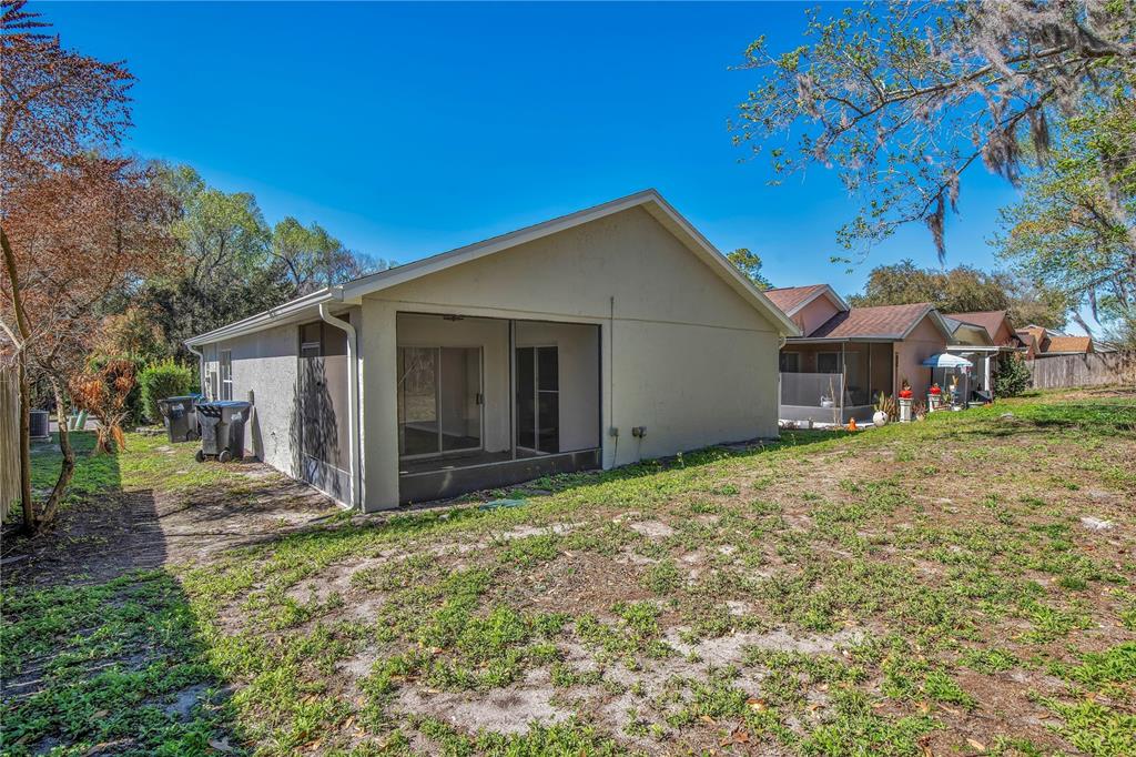1537 Rivers Edge Drive Orlando, FL 32825 - Photo 23 of 30 a view of a house with backyard and trees
