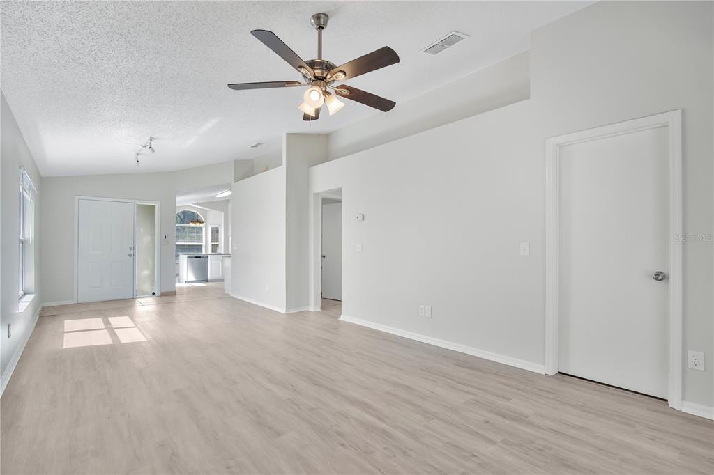 1537 Rivers Edge Drive Orlando, FL 32825 - Photo 6 of 30 wooden floor in an empty room with a window