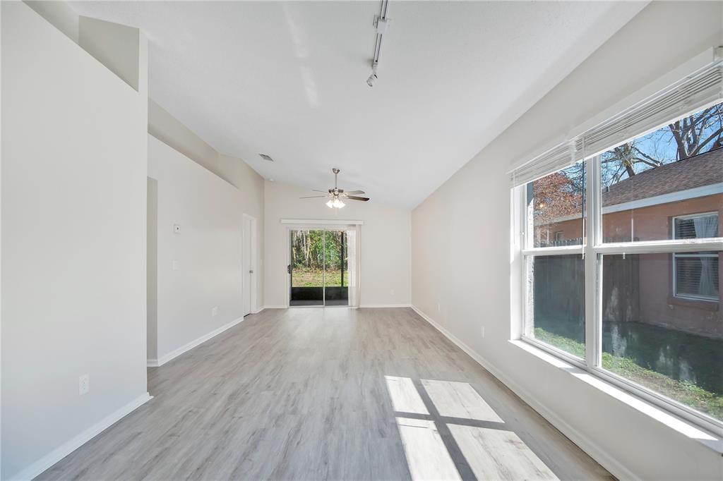 1537 Rivers Edge Drive Orlando, FL 32825 - Photo 7 of 30 a view of an empty room with a window and wooden floor