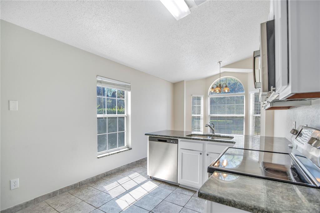 1537 Rivers Edge Drive Orlando, FL 32825 - Photo 8 of 30 a view of a kitchen with fridge and windows