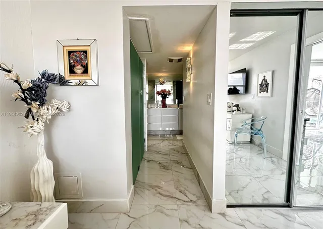 a view of a hallway with paintings on the wall