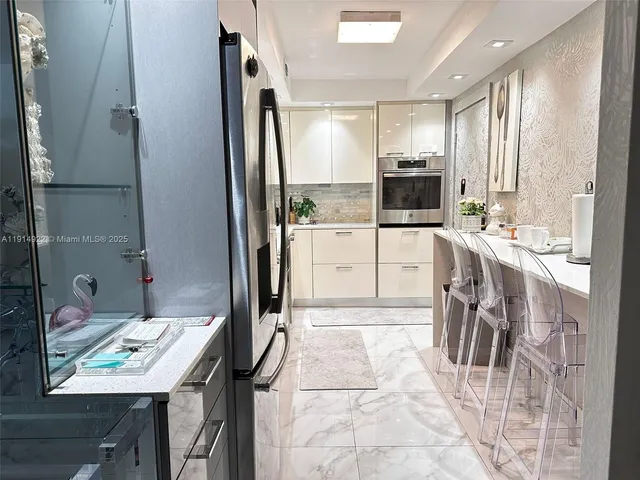 a large kitchen with a table and chairs