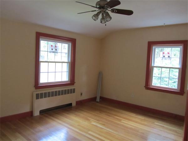 18 Constitution Road Lexington, MA 02421 - Photo 6 of 11 a view of an empty room with a window and wooden floor