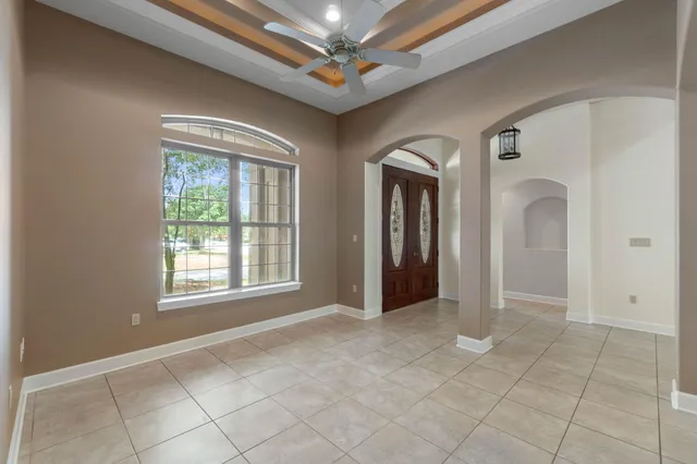 a spacious bedroom with a bed and a potted plant