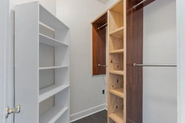 a bathroom with a double vanity sink a large mirror and a bathtub