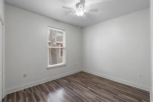 a spacious bathroom with a granite countertop sink a light fixture and a mirror