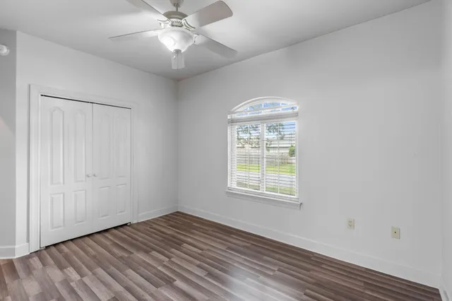 a bathroom with a granite countertop sink a toilet and a mirror
