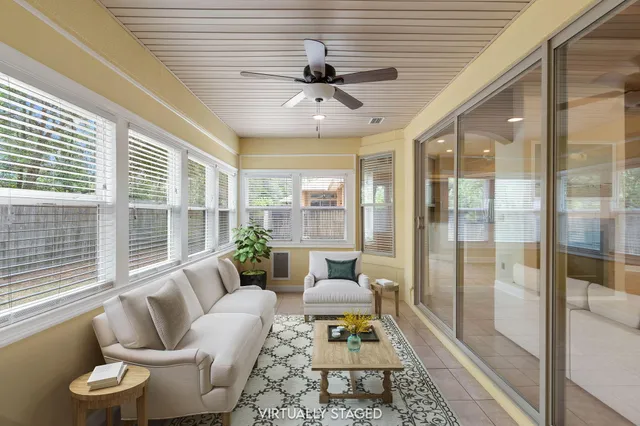 a view of a backyard with a large tree and wooden fence