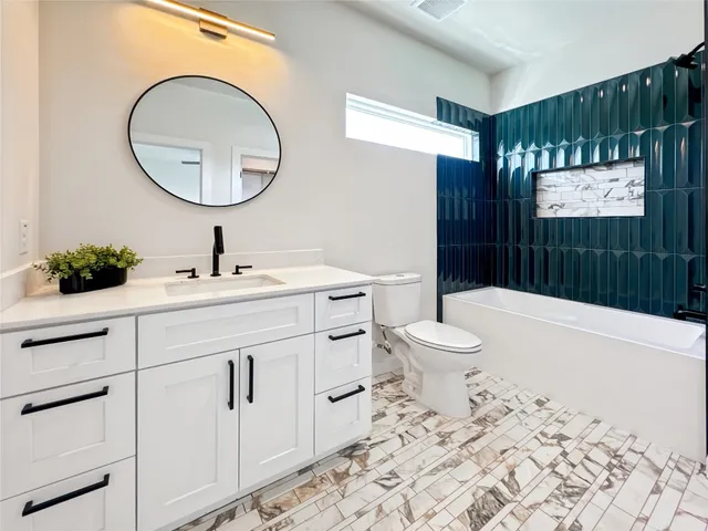 a bathroom with a sink a toilet and a mirror