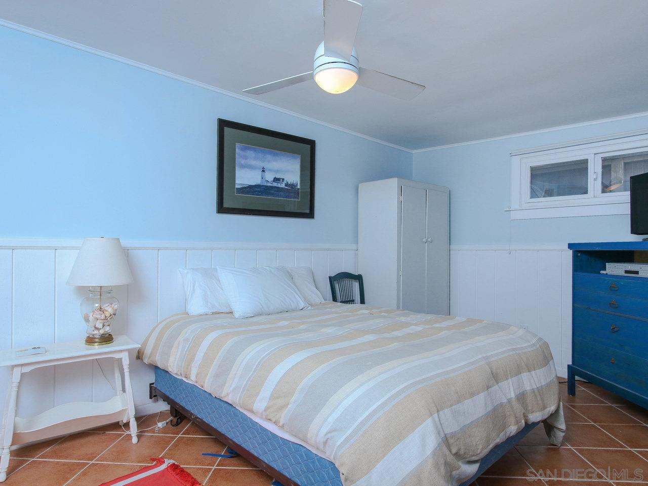 2212 Ocean Front Del Mar, CA 92014 - Photo 12 of 17 a bedroom with a bed and a lamp on dresser