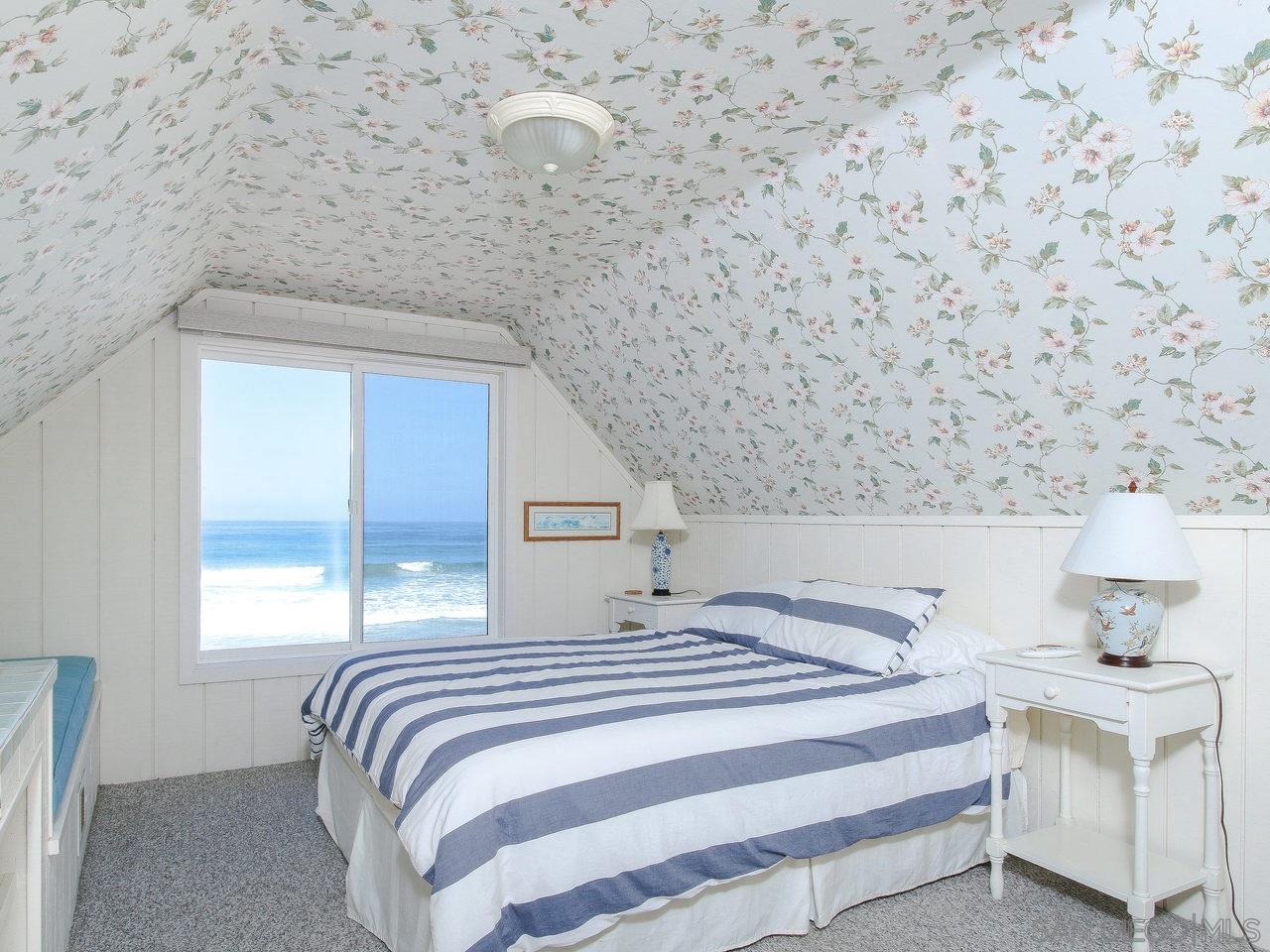 2212 Ocean Front Del Mar, CA 92014 - Photo 7 of 17 a bedroom with a bed and a window