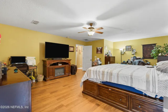 a bedroom with a bed and a dresser