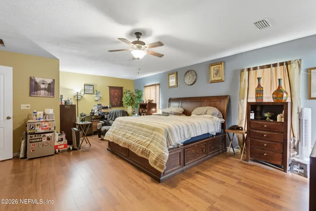 a room with a table chairs and a kitchen view