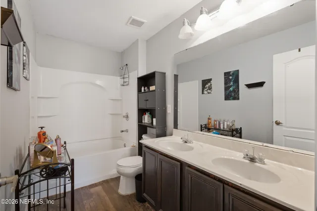 a bedroom with two beds and a flat screen tv