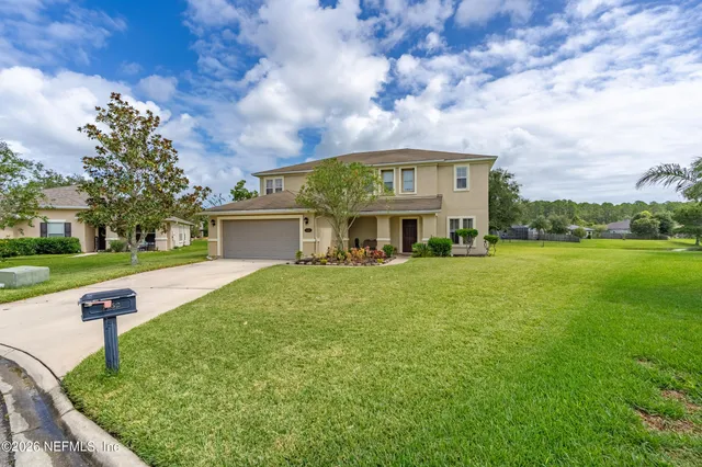 a view of house with yard and entertaining space