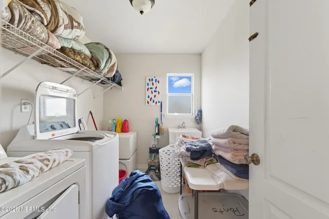 a view of a swimming pool and lounge chairs in back yard of the house