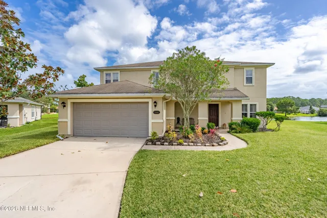 a front view of a house with garden