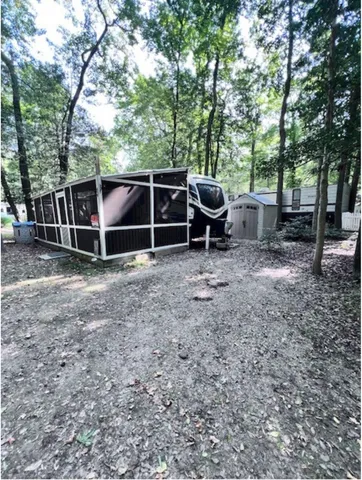 a backyard of a house with table and chairs